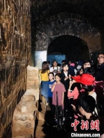 图为讲解员为游客讲述古墓的前世今生。　洛阳古代艺术博物馆供图 - 中国新闻社河南分社