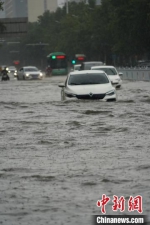 　图为郑州市区主干道积水漫过行驶车辆的车顶。　李超庆 摄 - 中国新闻社河南分社