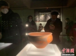图为游客在欣赏弧线三角纹彩陶盆。　扬子 摄 - 中国新闻社河南分社